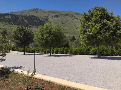 a large parking lot with trees and a mountain at Villa Mediterranea in Carini