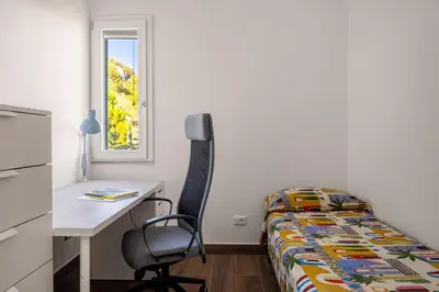 a bedroom with a desk and a bed and a desk and chair at Luce mediterranea a Monreale in Monreale