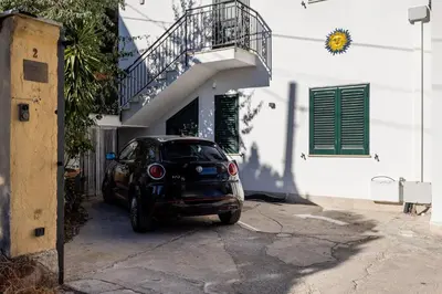 a small car parked in front of a building at Luce mediterranea a Monreale in Monreale