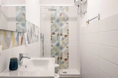a white bathroom with a sink and a toilet at Luce mediterranea a Monreale in Monreale