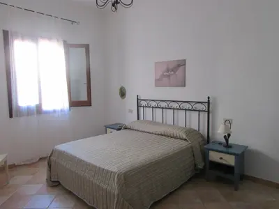a bedroom with a bed and a window at il limone appartamenti 2 in San Vito lo Capo