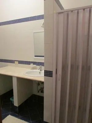 a bathroom with a sink and a mirror at il limone appartamenti 2 in San Vito lo Capo