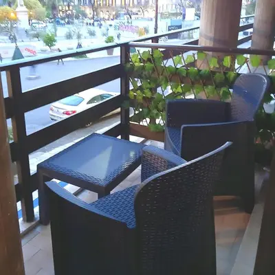 a couple of chairs and a table on a balcony at Domus Sicula Palermo city center in Palermo