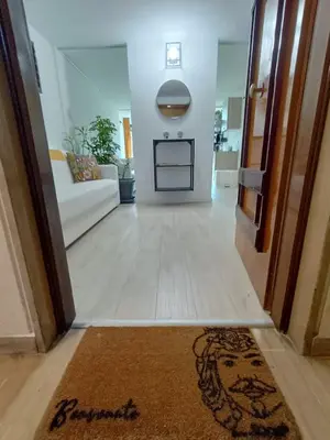 a hallway with a living room with a white couch at Domus Sicula Palermo city center in Palermo