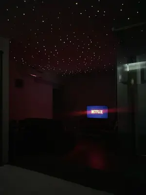 a dark room with a lit up sign on the wall at La casa del Cavaliere in Palermo