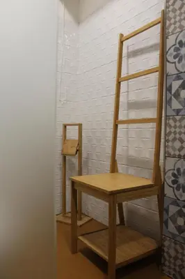a wooden shelf in a room with a wooden chair at La casa del Cavaliere in Palermo