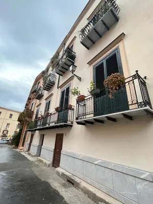 a building with balconies and potted plants on it at Palazzo dei Duchi D'Amico - Apartment -