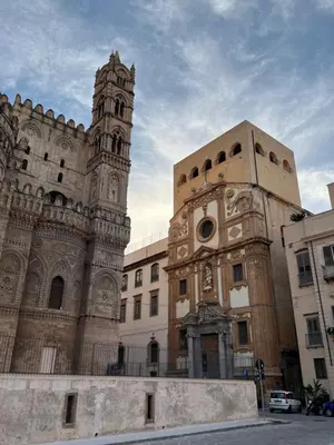 a large building with a clock tower in front of it at Palazzo dei Duchi D'Amico - Apartment -
