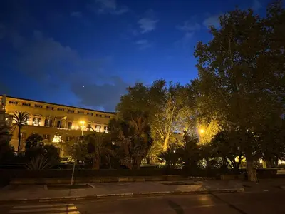 a building at night with trees in front of it at Palazzo dei Duchi D'Amico - Apartment -