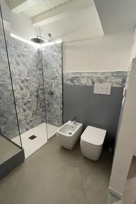a bathroom with a shower and a toilet and a sink at Palazzo dei Duchi D'Amico - Apartment -