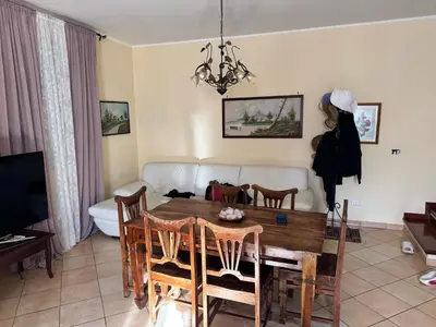 a dining room with a table and chairs and a couch at Villa Altavilla in Altavilla Milicia