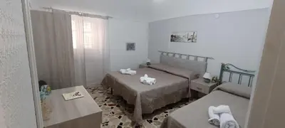 a bedroom with two beds with towels on them at Beneath the Castle in Corleone