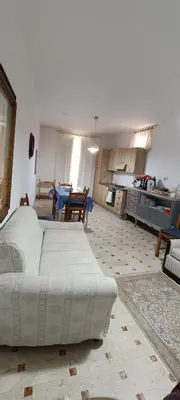 a large living room with a bed and a table at Beneath the Castle in Corleone