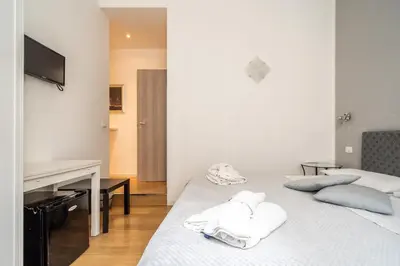 a bedroom with two beds with towels on them at B&b Glamour in Palermo