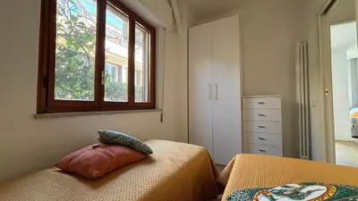 a bedroom with a bed and a window and a dresser at Villa Emilia Mondello Appartamento Vita Alba con vista sul mare in Mondello