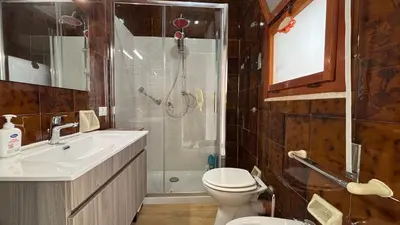 a bathroom with a shower and a toilet and a sink at Villa Emilia Mondello Appartamento Vita Alba con vista sul mare in Mondello