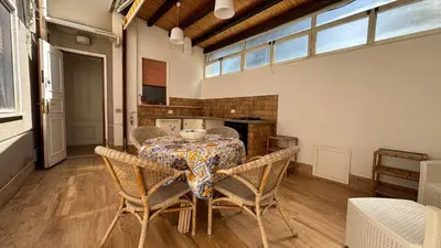a dining room with a table and chairs at Villa Emilia Mondello Appartamento Vita Alba con vista sul mare in Mondello