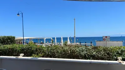 a view of a beach with the ocean in the background at Villa Emilia Mondello Appartamento Vita Alba con vista sul mare in Mondello