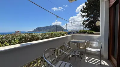 a balcony with a table and chairs and the ocean at Villa Emilia Mondello Appartamento Vita Alba con vista sul mare in Mondello