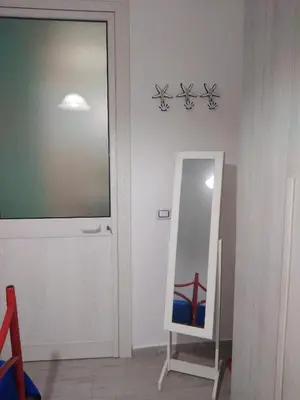 a mirror in a room with a door and a mirror at Casa Ferdinando e Maria in Palermo