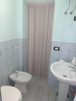 a bathroom with a toilet and a sink at Casa Ferdinando e Maria in Palermo