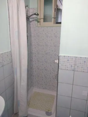 a bathroom with a shower with a shower curtain at Casa Ferdinando e Maria in Palermo
