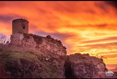 a building on top of a hill with a sunset at Corleone bed and breakfast in Corleone