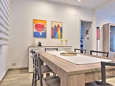 a dining room with a wooden table and chairs at Casa Belsito in Palermo