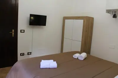 a bedroom with a bed with two towels on it at Talitha in Palermo