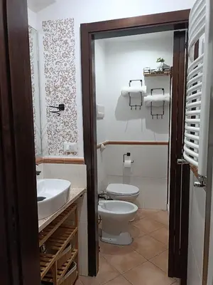 a bathroom with a toilet and a sink at Talitha in Palermo