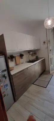 a kitchen with a sink and a refrigerator at Casa vacanze dispensa San Pietro in Calatafimi