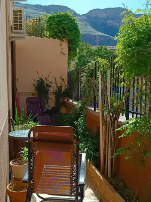a chair on the balcony of a house at La casetta di Cecilia in Palermo