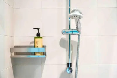 a shower with a shower head in a bathroom at Mazzini Suites Palermo in Palermo