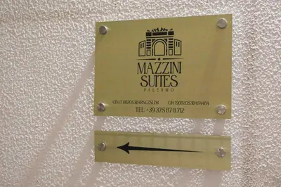 a hallway in a building with orange walls at Mazzini Suites Palermo in Palermo