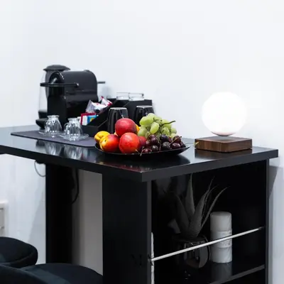 a table with a plate of fruit on it at MEA Suite in Palermo