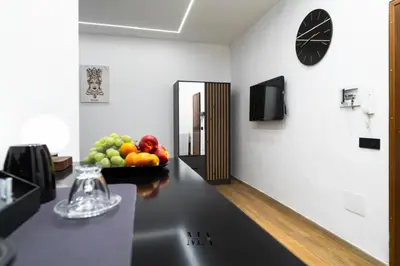 a room with a bowl of fruit on a counter at MEA Suite in Palermo