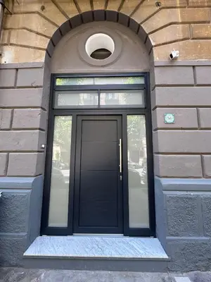 a black door in a brick building at Sammartino Apartment in Palermo