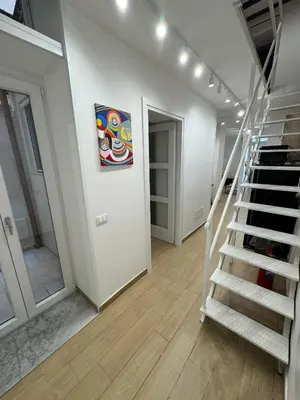 a room with stairs and a painting on the wall at Sammartino Apartment in Palermo