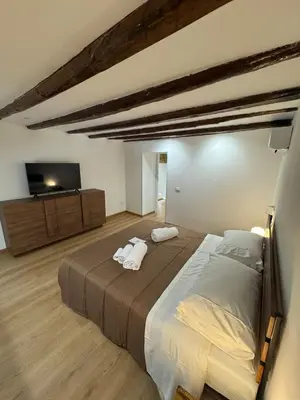 a bedroom with a large bed with two towels on it at Sammartino Apartment in Palermo