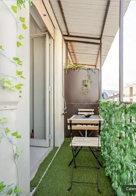 a small balcony with a table and a plant at Dolce Sicily a 1km dal centro in Palermo