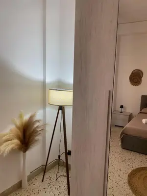 a living room with a lamp and a bed at Dolce Sicily a 1km dal centro in Palermo