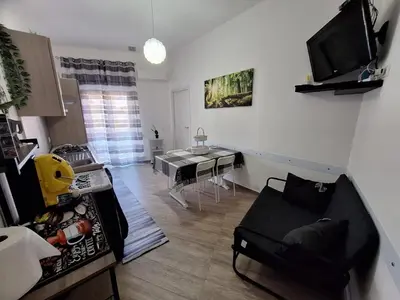 a living room with a couch and a table at Tukory Central room Palermo in Palermo