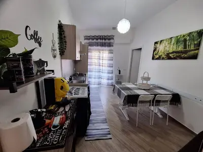a kitchen and dining room with a table and chairs at Tukory Central room Palermo in Palermo