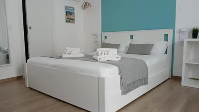 a white bed with two towels on top of it at Esse & Emme in Palermo