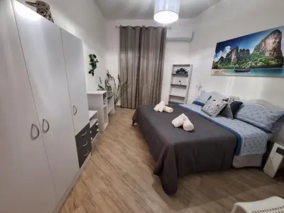 a bedroom with a bed with two towels on it at Normanni Deluxe Room Palermo in Palermo