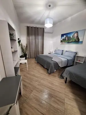 a bedroom with a large bed in a room at Normanni Deluxe Room Palermo in Palermo