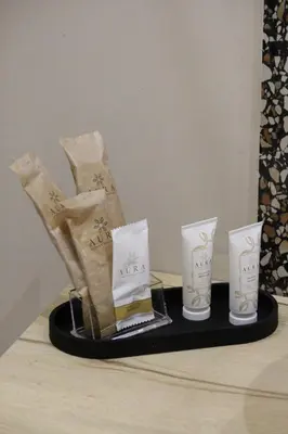 a display of boots and candles on a shelf at Leoni di Sicilia in Palermo
