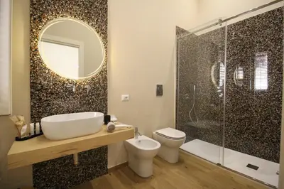 a bathroom with a toilet and a sink and a shower at Leoni di Sicilia in Palermo