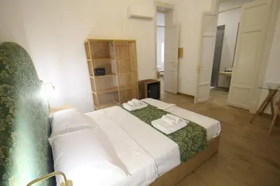 a bedroom with a bed with two towels on it at Leoni di Sicilia in Palermo