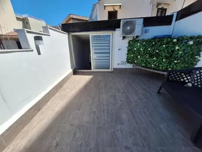 a balcony of a house with a bench and a building at Cattedrale Superior Room plus Terrace Palermo in Palermo